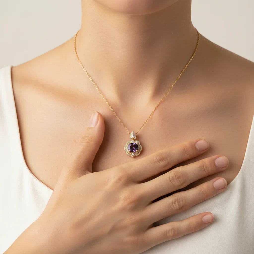 Necklace with a pendant worn by a person, hand resting on chest.