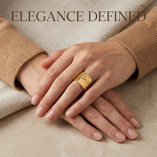 Gold ring on a hand with 'Elegance Defined' text