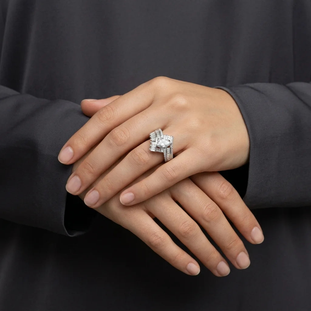 Hand wearing a diamond ring with a dark background