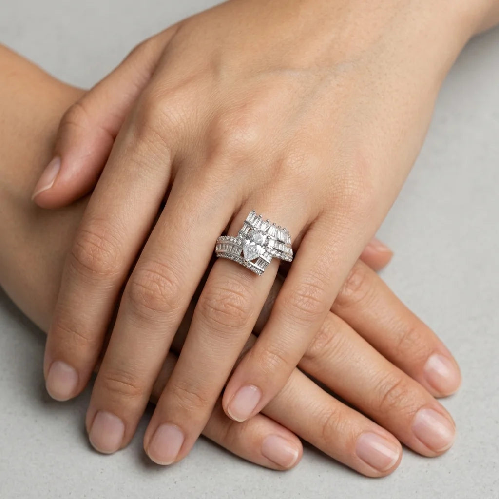 Close-up of a hand wearing a silver ring on a neutral background