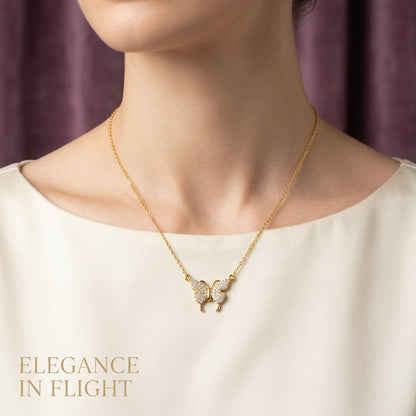 Gold butterfly necklace on a model with 'Elegance in Flight' text