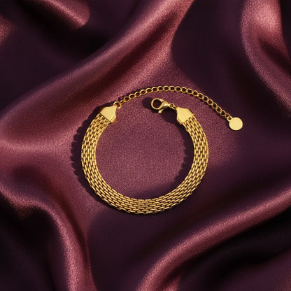 Gold bracelet on a purple satin background