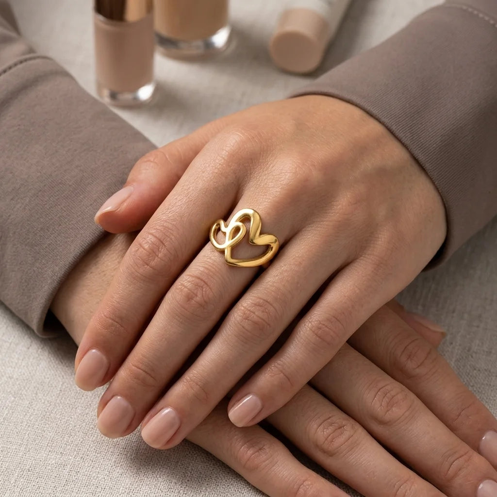 Gold ring on a hand with beige background