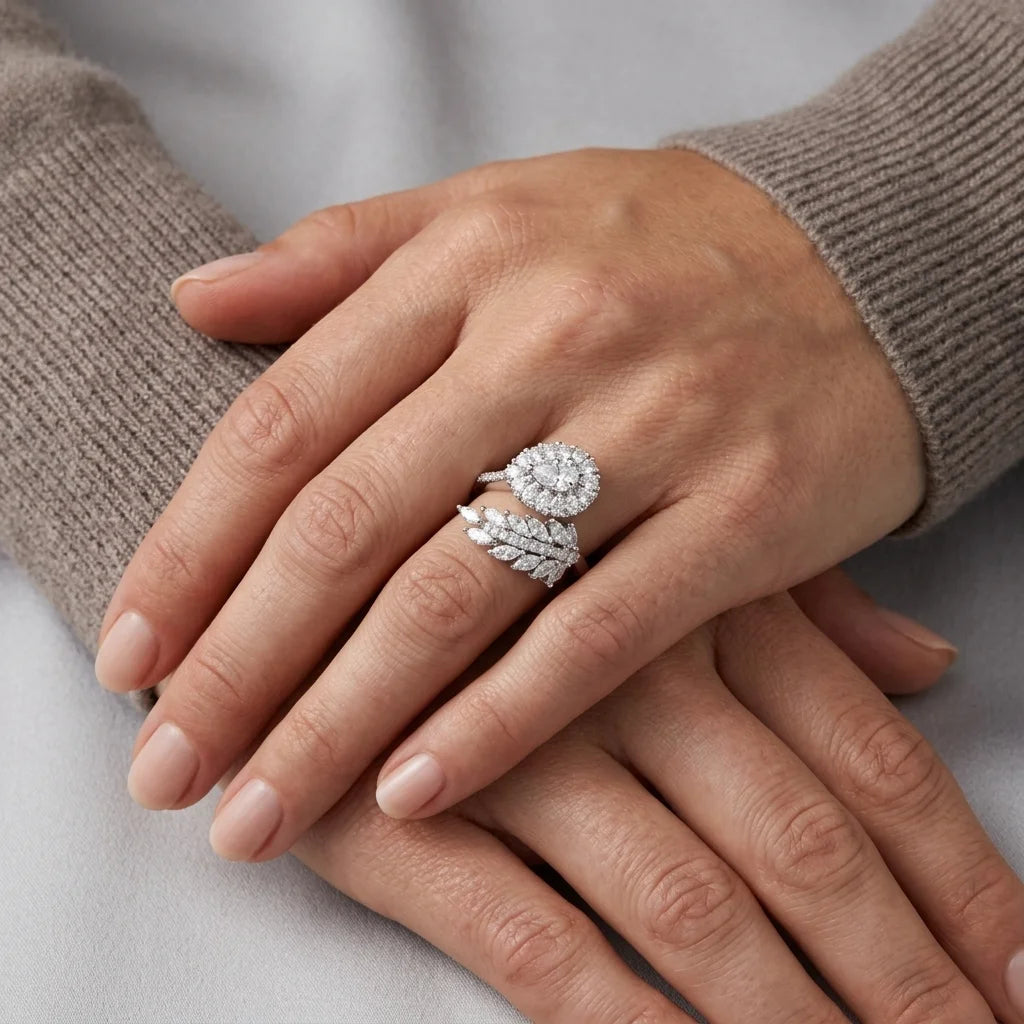 Close-up of hands wearing diamond rings on a neutral background