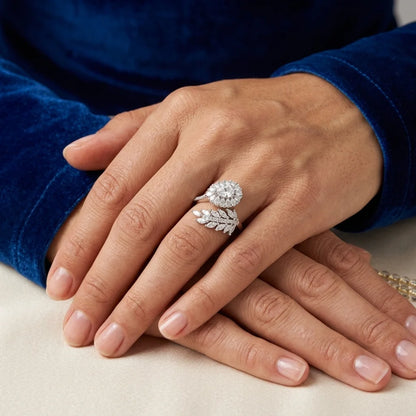 Close-up of hands wearing diamond rings on a neutral background