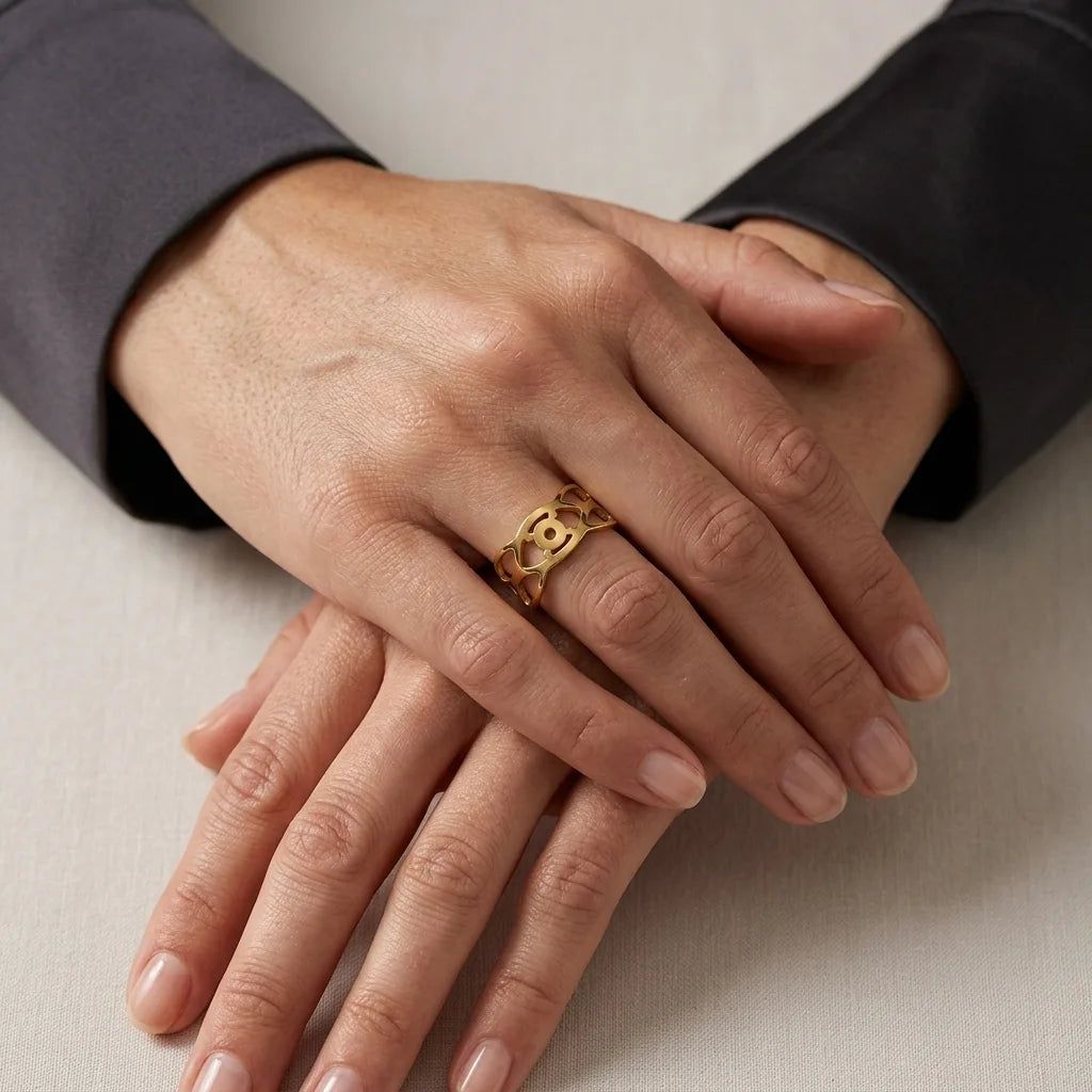 Close-up of hands with a gold ring on a neutral background