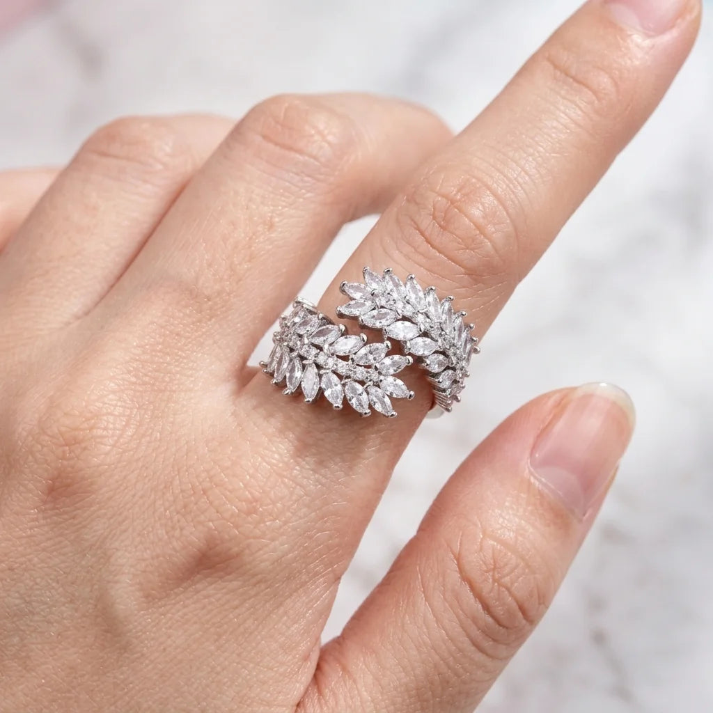 Close-up of a hand wearing a sparkling diamond ring on a blurred background