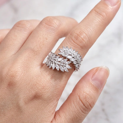Close-up of a hand wearing a sparkling diamond ring on a blurred background