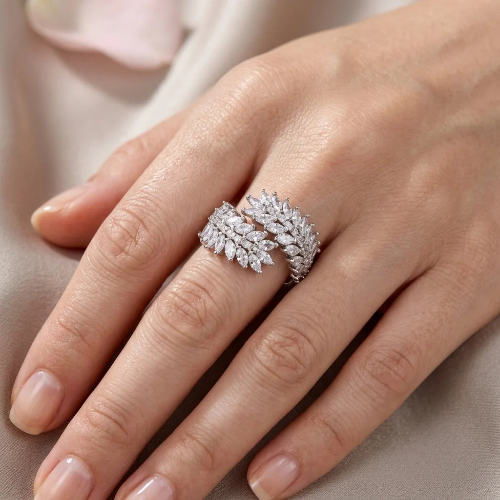 Silver ring with diamonds on a hand against a neutral background