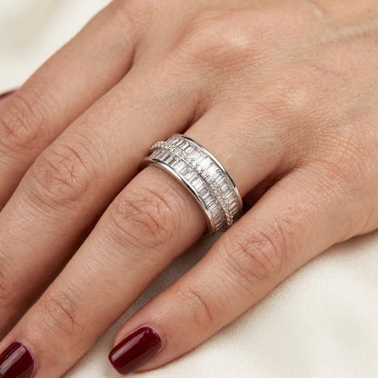 Close-up of a hand wearing a silver ring with a white background