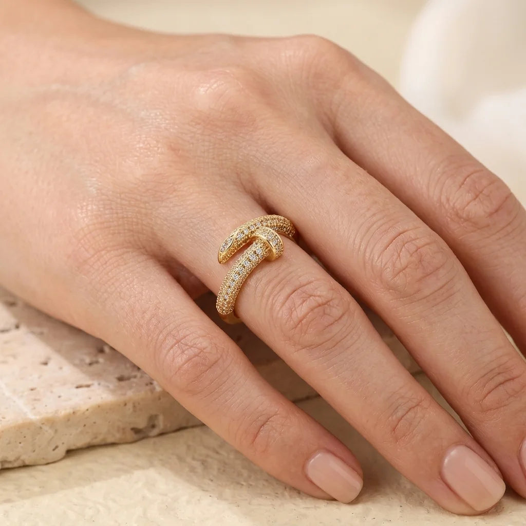 Gold ring on a person's finger with a neutral background