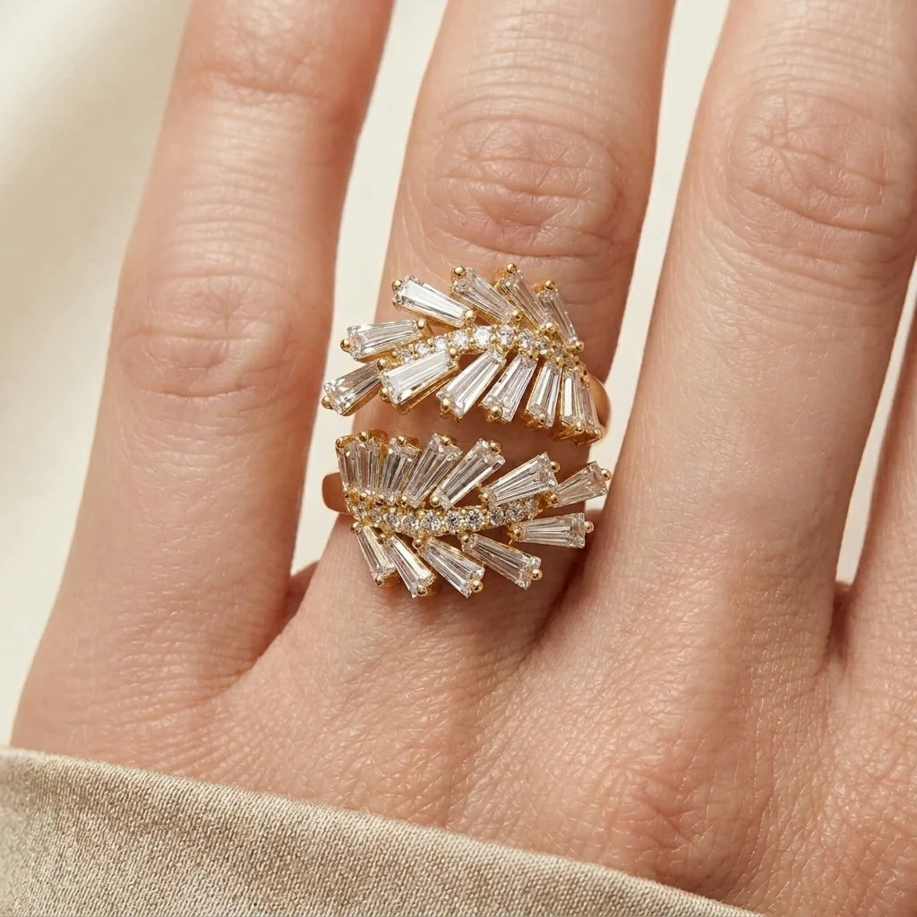 Gold and diamond ring on a finger against a neutral background