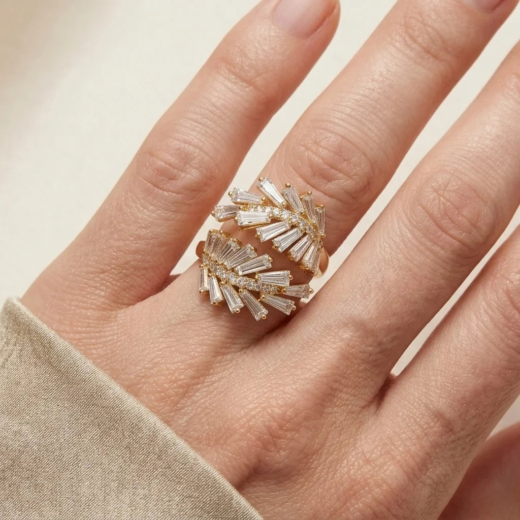 Close-up of a hand wearing a decorative ring with a beige background