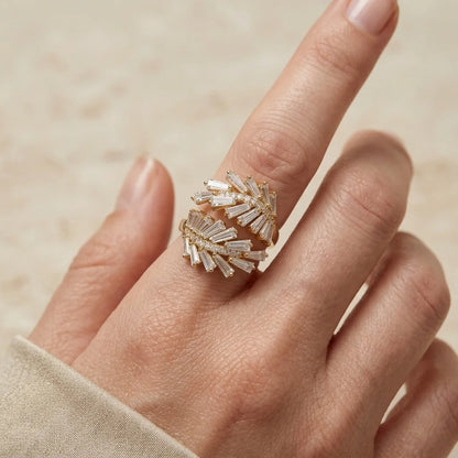 Hand wearing a decorative ring with a beige background