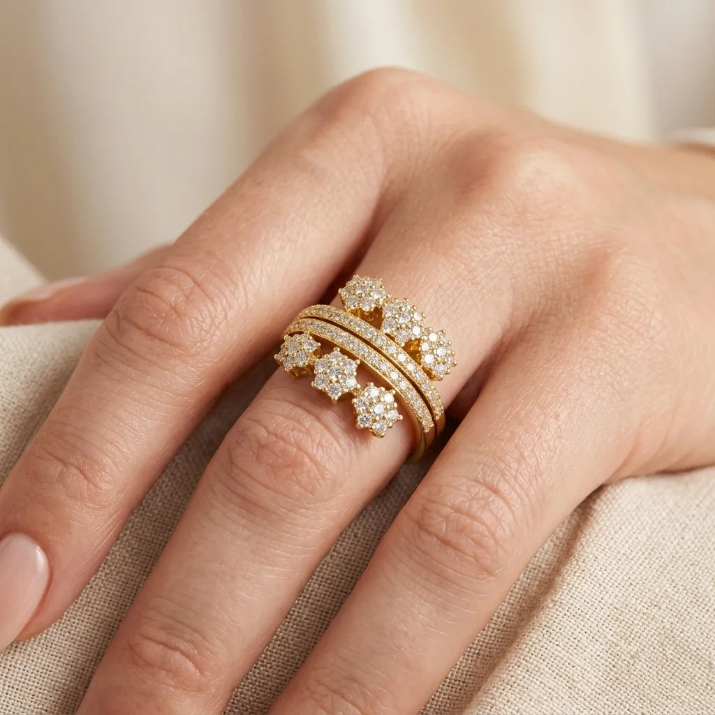 Gold ring with diamonds on a hand against a beige fabric background