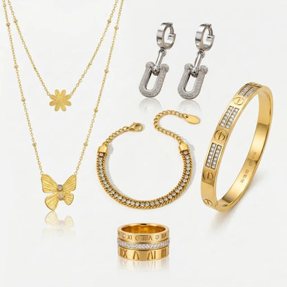Collection of gold and silver jewelry including necklaces, bracelets, and rings on a white background.