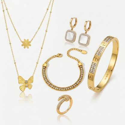 Collection of gold jewelry including necklace, earrings, bracelet, and rings on a white background