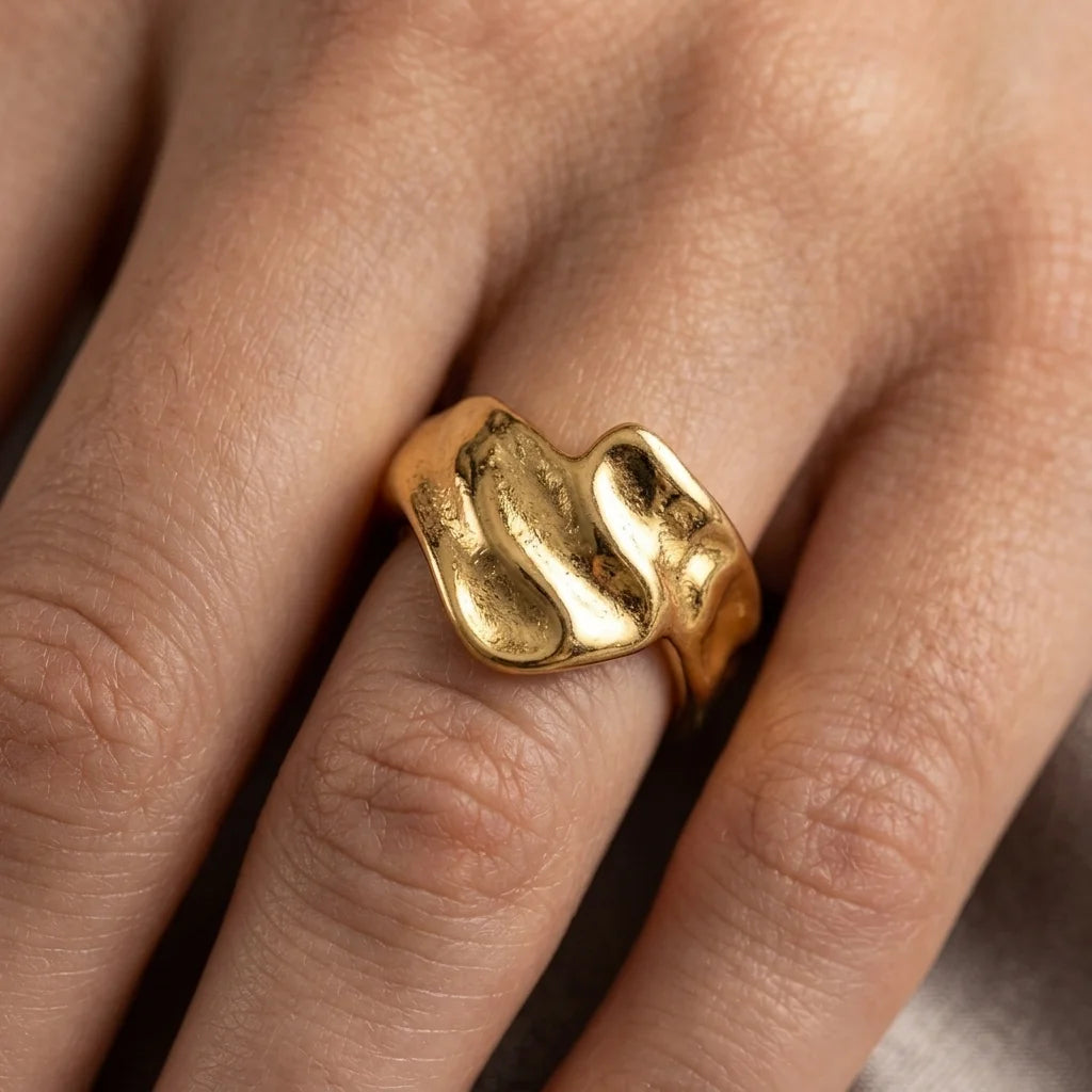 Gold ring on a finger with a blurred background