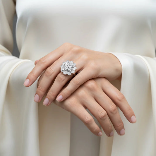 Hand wearing a diamond ring with a soft focus background