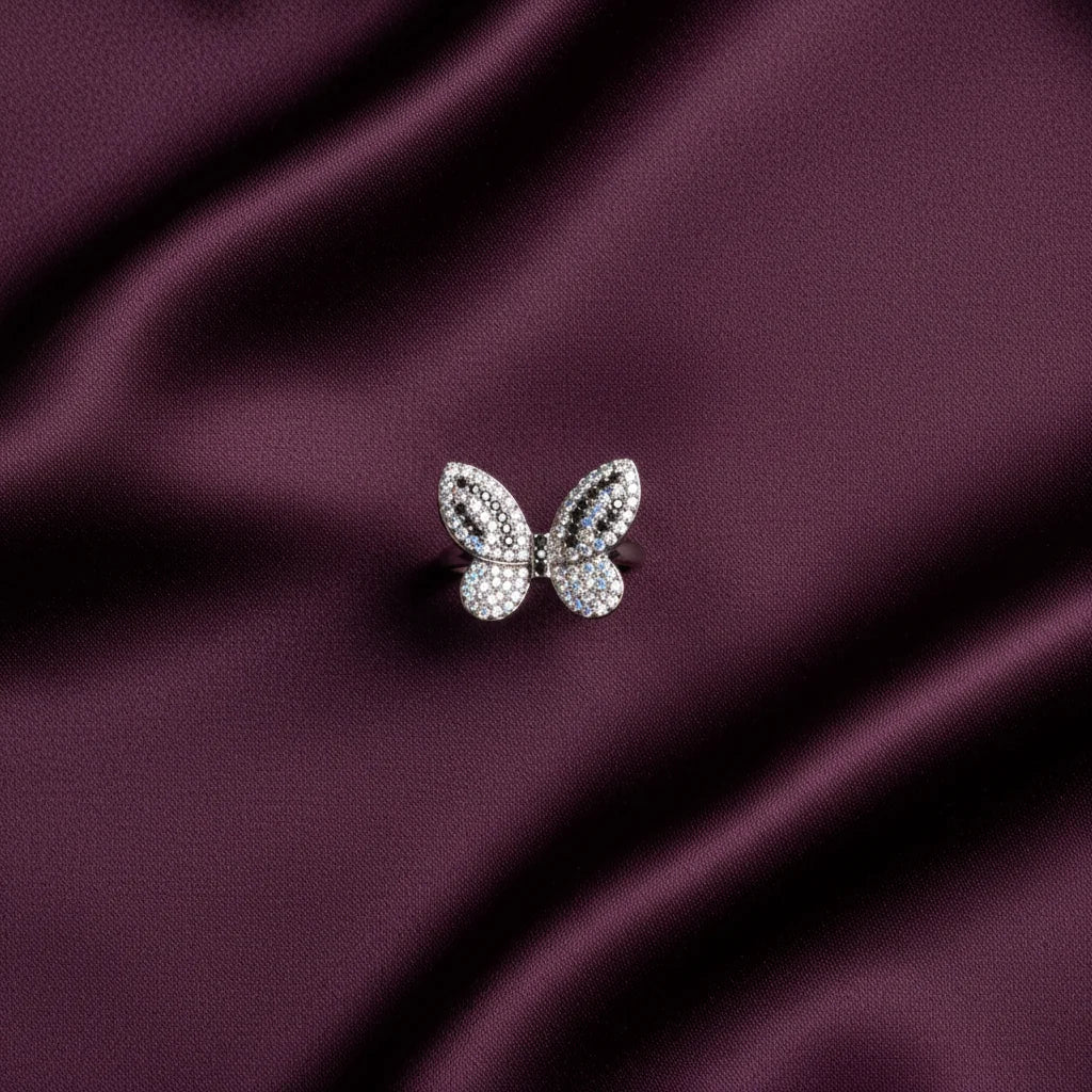 Butterfly-shaped jewelry on a purple satin background