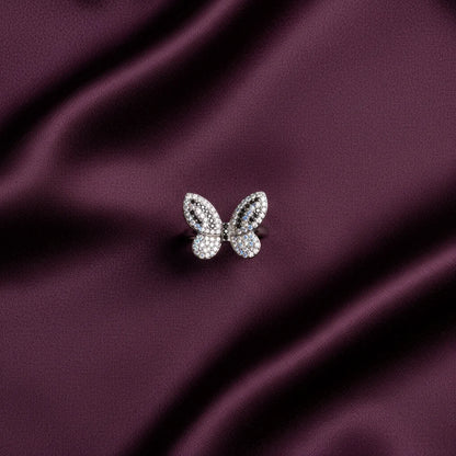 Butterfly-shaped jewelry on a purple satin background