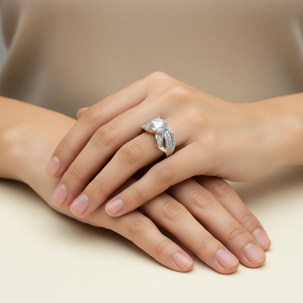 Close-up of a hand wearing a diamond ring on a neutral background