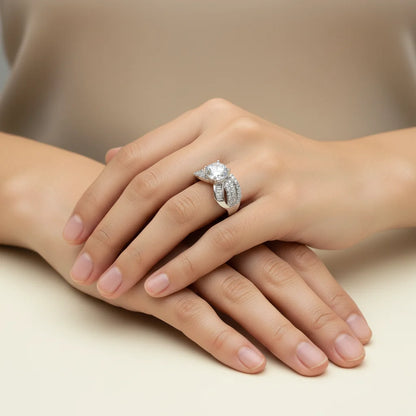 Close-up of a hand wearing a diamond ring on a neutral background