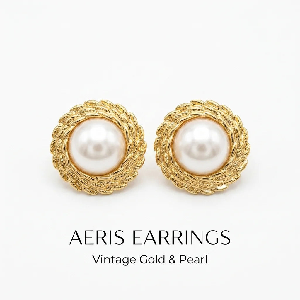 Pair of AERIS earrings with gold frames and pearl centers on a white background