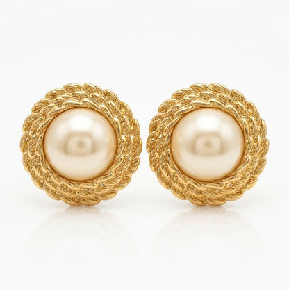 Pair of gold earrings with pearl centers on a white background