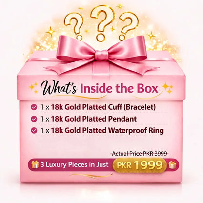 Pink gift box with gold bow and text about jewelry contents on a white background