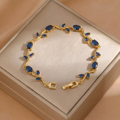 Gold bracelet with blue stones on a beige box