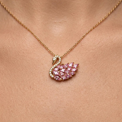 Pink swan necklace with gemstones on a person's neck