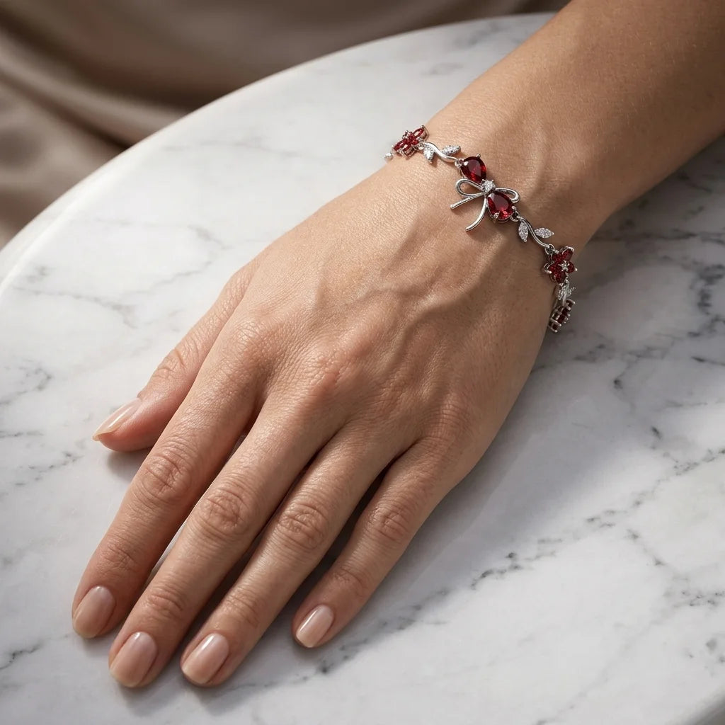 Hand wearing a decorative bracelet on a marble surface