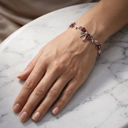 Hand wearing a decorative bracelet on a marble surface