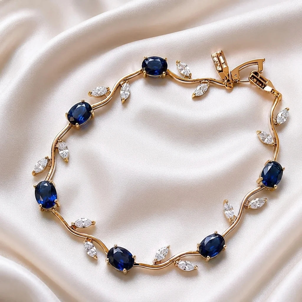 Gold bracelet with blue gemstones on a beige fabric background