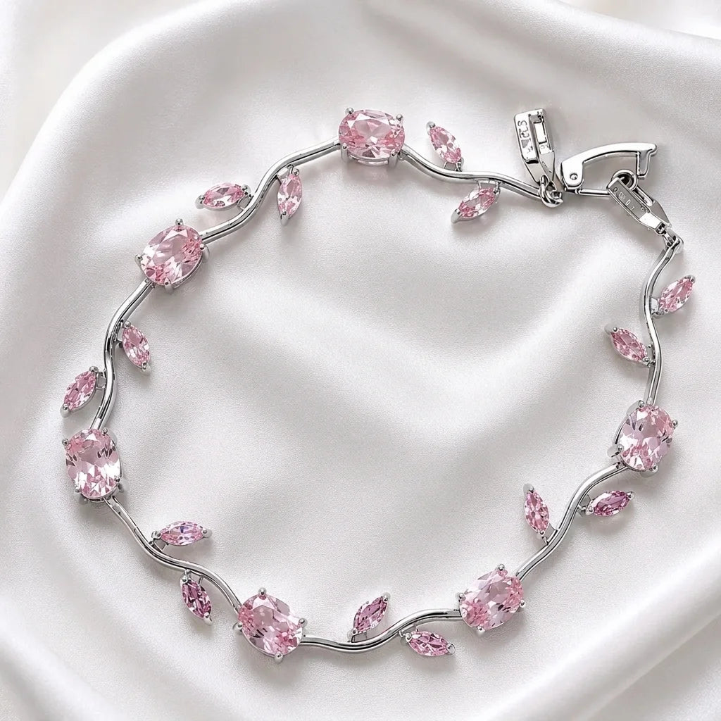 Silver bracelet with pink gemstones on a white background