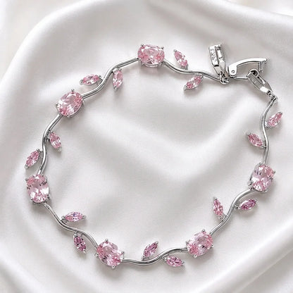 Silver bracelet with pink gemstones on a white background