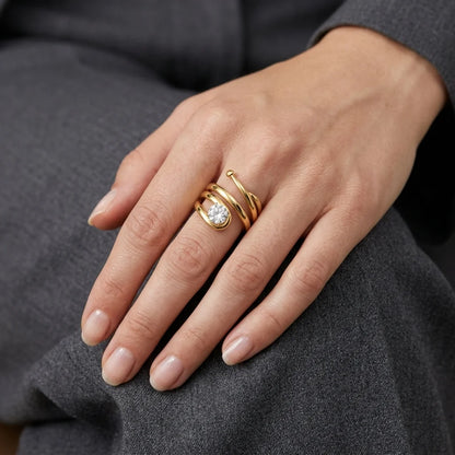 Luxury gold wraparound ring showcasing craftsmanship and a large round‑cut gem.