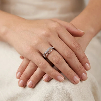 UPT silver pavé wave ring stacked with a polished wave band, worn on hand against cream linen