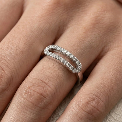 Close‑up of a silver oval ring with two rows of sparkling diamonds.