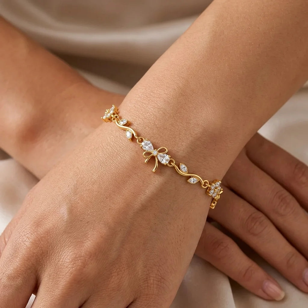 Crystal-white zircon blooms and a delicate bow. A bright, bridal-ready take on the viral vine bracelet.