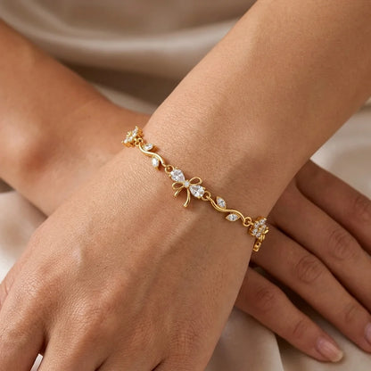 Crystal-white zircon blooms and a delicate bow. A bright, bridal-ready take on the viral vine bracelet.