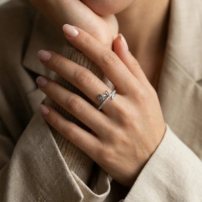 Silver Luminous Rosa ring worn on a woman's hand, styled with a neutral blazer