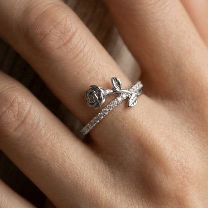 Close-up of silver Luminous Rosa double-band ring with bow detail and sparkling stones