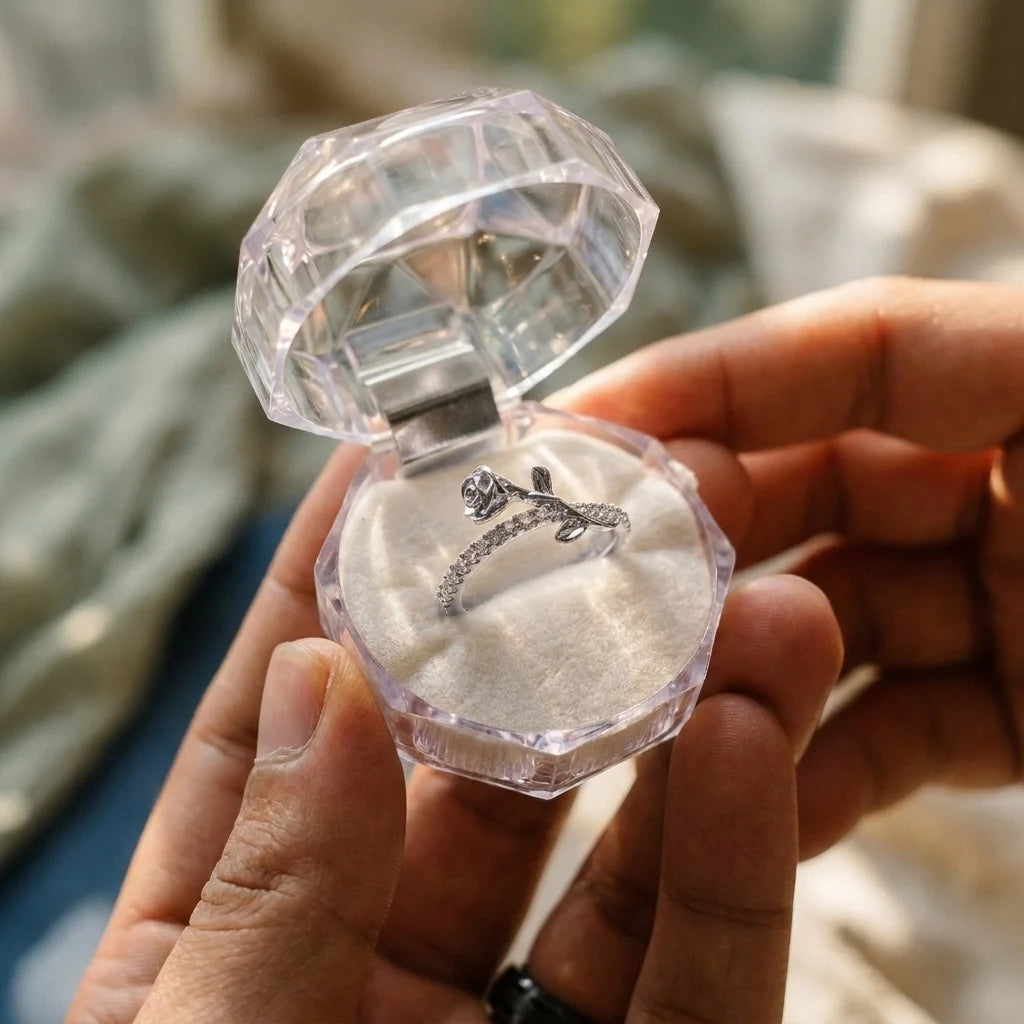 Free clear octagonal gift ring case with Luminous Rosa ring inside, held open by hand