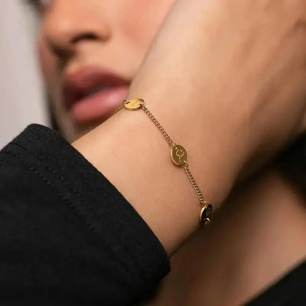Gold bracelet on a wrist with a blurred background