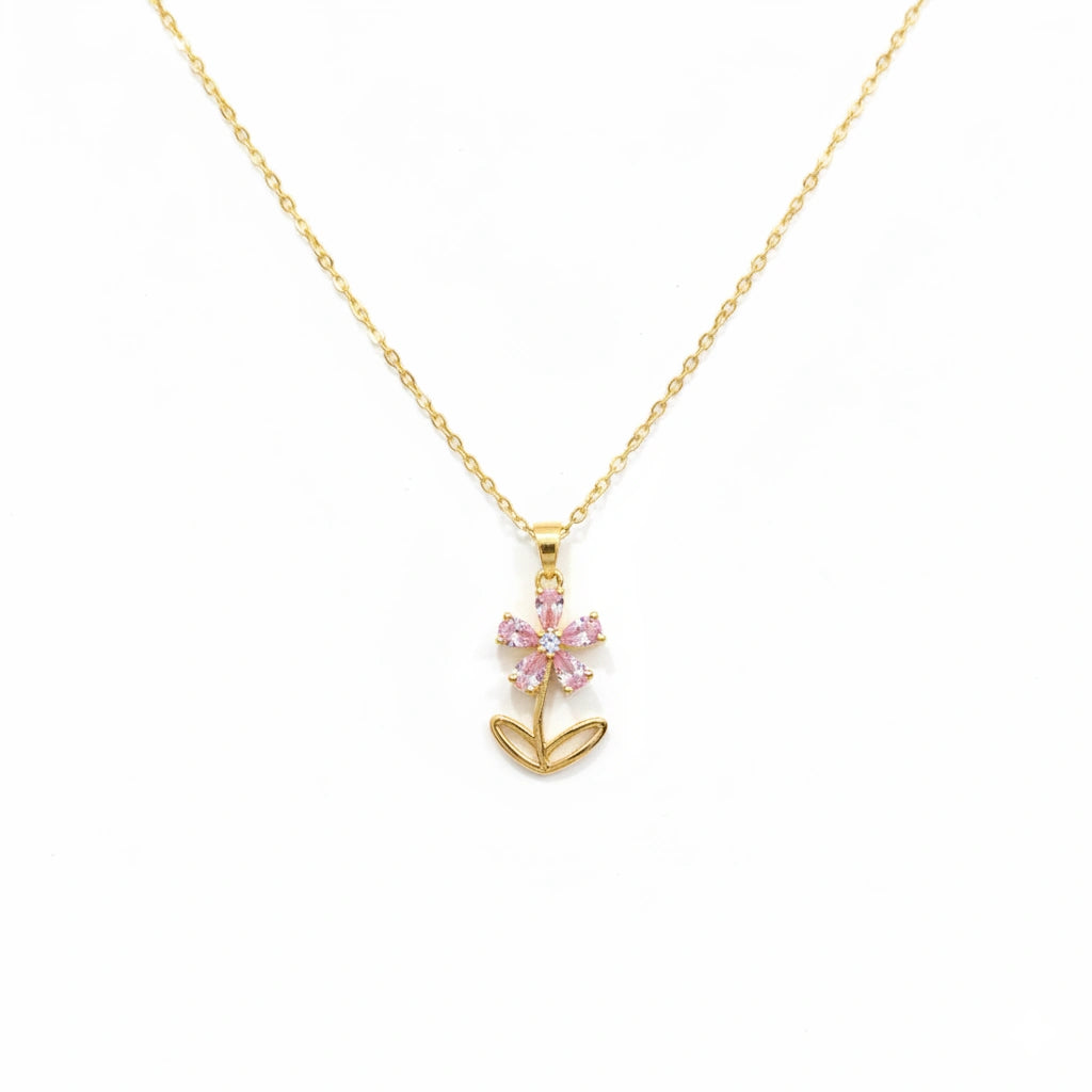 Gold necklace with a pink flower pendant on a white background