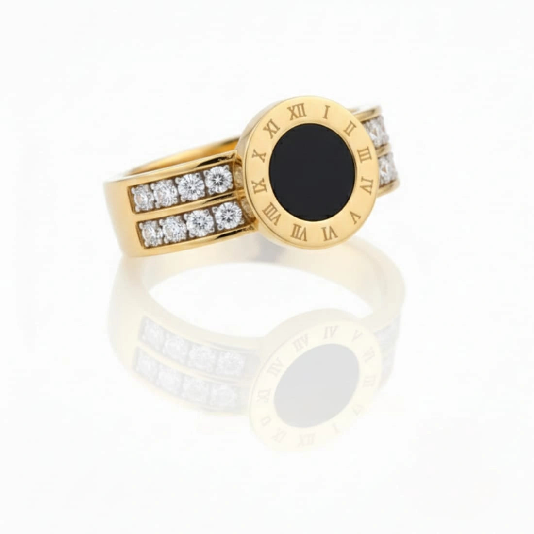 Gold ring with black center and diamond accents on a white background