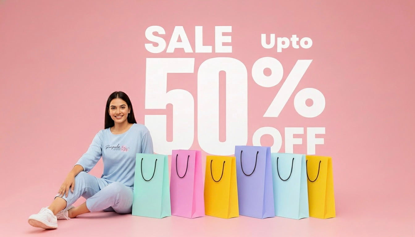 Woman sitting with colorful shopping bags and 'Sale Upto 50% Off' text on a pink background
